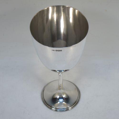 A handsome Antique Victorian Sterling Silver goblet, having a plain round tapering body, and sitting on a plain pedestal foot with an applied bead border. Made by Henry Wilkinson of Sheffield in 1900. The dimensions of this fine hand-made antique silver goblet are height 16.5 cms (6.5 inches), diameter at lip 8 cms (3.25 inches), and it weighs approx. 142g (4.6 troy ounces).