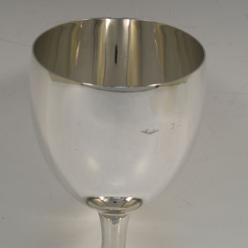 A very handsome Sterling Silver goblet, having a plain round tapering body, and sitting on a pedestal foot with a hand-engraved reeded border. This elegant silver wine goblet was made in London in 1928. The dimensions of this fine hand-made silver goblet are height 16 cms (6.3 inches), diameter at lip 9 cms (3.5 inches), and it weighs approx. 226g (7.3 troy ounces).   