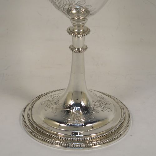 A very pretty Antique Victorian Sterling Silver goblet, having a round bellied body with hand-engraved tree and leaf floral decoration, a gold-gilt interior, and sitting on a pedestal foot with an applied double bead-edged border. This beautiful silver goblet was made by Thomas Smiley of London in 1870. The dimensions of this fine hand-made antique silver goblet are height 16.5 cms (6.5 inches), diameter at lip 8 cms (3.25 inches), and it weighs approx. 172g (5.5 troy ounces).   