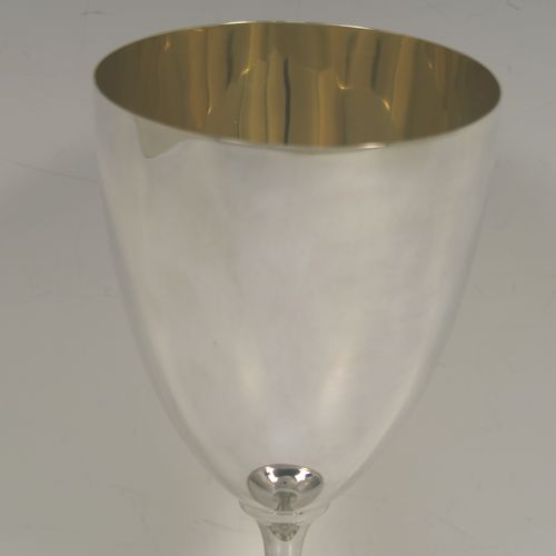 An elegant Antique Victorian Sterling Silver wine goblet, having a plain round body, a gold-gilt interior, and all sitting on a pedestal foot with an applied bead-edged border. This handsome antique silver wine goblet was made by Henry Wilkinson of Sheffield in 1898. The dimensions of this fine hand-made silver goblet are height 19 cms (7.5 inches), diameter of body at lip 9 cms (3.5 inches), and it weighs approx.202g (6.5 troy ounces).