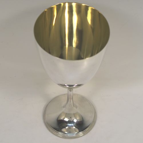 An elegant Antique Victorian Sterling Silver wine goblet, having a plain round body, a gold-gilt interior, and all sitting on a pedestal foot with an applied bead-edged border. This handsome antique silver wine goblet was made by Henry Wilkinson of Sheffield in 1898. The dimensions of this fine hand-made silver goblet are height 19 cms (7.5 inches), diameter of body at lip 9 cms (3.5 inches), and it weighs approx.202g (6.5 troy ounces).