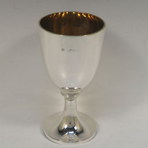 A very handsome Antique Victorian Sterling Silver goblet, having a plain round tapering body with a gold-gilt interior, and sitting on a pedestal foot with an applied upper reeded band. This elegant antique silver wine goblet was made by the Harris Brothers of London in 1897. The dimensions of this fine hand-made antique silver goblet are height 18 cms (7 inches), diameter at lip 9 cms (3.5 inches), and it weighs approx. 257g (8.3 troy ounces). Please note that this item is crested on one side. 