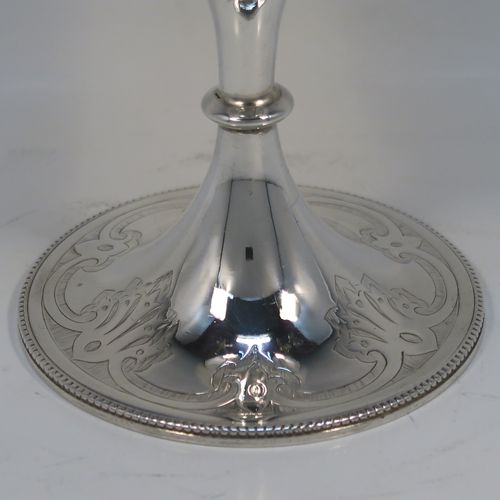 A very pretty Antique Victorian Sterling Silver goblet, having a round body with tapering sides and hand-engraved floral and scroll decoration, a gold-gilt interior, and sitting on a pedestal foot with hand-engraved decoration and an applied bead-edged border. This beautiful silver goblet was made by Joseph Rogers of Sheffield in 1875. The dimensions of this fine hand-made antique silver goblet are height 17 cms (6.6 inches), diameter at lip 9 cms (3.5 inches), and it weighs approx. 211g (6.8 troy ounces).  