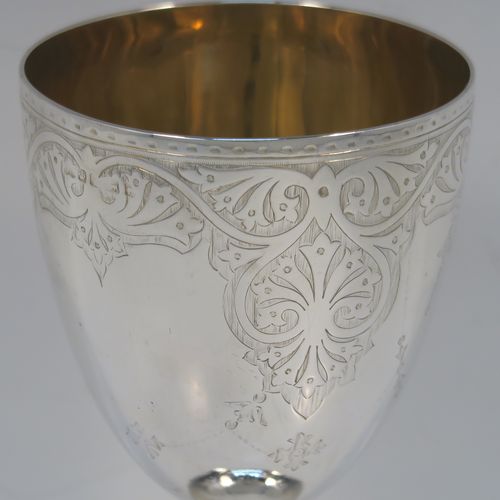 A very pretty Antique Victorian Sterling Silver goblet, having a round body with tapering sides and hand-engraved floral and scroll decoration, a gold-gilt interior, and sitting on a pedestal foot with hand-engraved decoration and an applied bead-edged border. This beautiful silver goblet was made by Joseph Rogers of Sheffield in 1875. The dimensions of this fine hand-made antique silver goblet are height 17 cms (6.6 inches), diameter at lip 9 cms (3.5 inches), and it weighs approx. 211g (6.8 troy ounces).  
