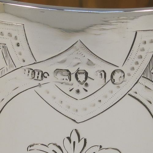 A pretty Antique Victorian Sterling Silver goblet, having a round bellied body with hand-engraved floral and scroll decoration, a gold-gilt interior, and sitting on a pedestal foot with hand-engraved decoration and an applied bead-edged border. This beautiful silver goblet was made by Henry Holland of London in 1870. The dimensions of this fine hand-made antique silver goblet are height 16.5 cms (6.5 inches), diameter at lip 8.5 cms (3.3 inches), and it weighs approx. 188g (6 troy ounces).