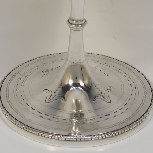 A pretty Antique Victorian Sterling Silver goblet, having a round bellied body with hand-engraved floral and scroll decoration, a gold-gilt interior, and sitting on a pedestal foot with hand-engraved decoration and an applied bead-edged border. This beautiful silver goblet was made by Henry Holland of London in 1870. The dimensions of this fine hand-made antique silver goblet are height 16.5 cms (6.5 inches), diameter at lip 8.5 cms (3.3 inches), and it weighs approx. 188g (6 troy ounces).