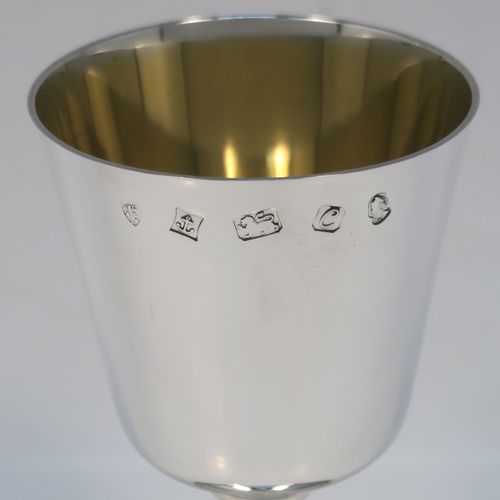 A very handsome set of twelve Sterling Silver  goblets, having plain round tapering bodies with gold-gilt interiors, sitting on round baluster stems  and plain pedestal feet with reeded borders. This beautiful set of silver goblets were all made by J. B. Chatterley of Birmingham in 1977. The dimensions of these fine hand-made set of silver goblets are height 12.5 cms (5 inches), diameter at lip 6.5 cms (2.5 inches), and they weigh a total of approx. 980g (62 troy ounces).   