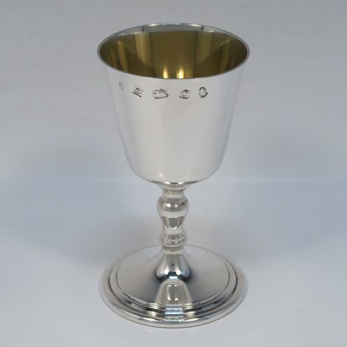 A very handsome set of twelve Sterling Silver  goblets, having plain round tapering bodies with gold-gilt interiors, sitting on round baluster stems  and plain pedestal feet with reeded borders. This beautiful set of silver goblets were all made by J. B. Chatterley of Birmingham in 1977. The dimensions of these fine hand-made set of silver goblets are height 12.5 cms (5 inches), diameter at lip 6.5 cms (2.5 inches), and they weigh a total of approx. 980g (62 troy ounces).   