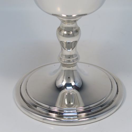 A very handsome set of twelve Sterling Silver  goblets, having plain round tapering bodies with gold-gilt interiors, sitting on round baluster stems  and plain pedestal feet with reeded borders. This beautiful set of silver goblets were all made by J. B. Chatterley of Birmingham in 1977. The dimensions of these fine hand-made set of silver goblets are height 12.5 cms (5 inches), diameter at lip 6.5 cms (2.5 inches), and they weigh a total of approx. 980g (62 troy ounces).   
