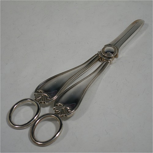 A very handsome and heavy Sterling Silver pair of grape shears or scissors in a double struck pattern with reeded borders and shell and scroll terminals. Made by Charles Boyton and Sons of Sheffield in 1931. The dimensions of this fine hand-made pair of silver grape scissors or shears are length 18 cms (7 inches), and they weigh approx. 123g (4 troy ounces).