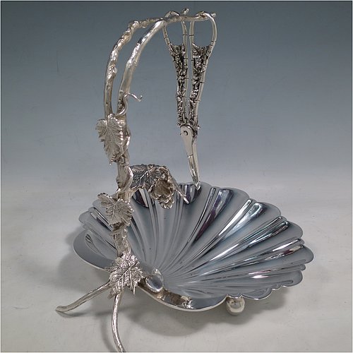 An Antique Victorian silver-plated grape dish stand with a pair of original grape shears in the Grapevine pattern, with cast vine-leaf tendrils, and a shell-style dish, sitting on three ball feet. All made by William Hutton & Sons of Sheffield in ca. 1880. The dimensions of this fine hand-made antique silver plated grape dish stand and scissors are height 27 cms (10.5 inches), width 25.5 cms (10 inches), and length 25.5 cms (10 inches).   