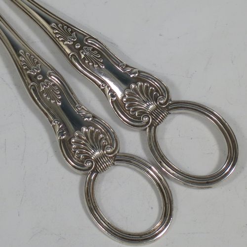 A very pretty Antique Victorian Sterling Silver pair of grape shears or scissors in the double struck Kings pattern with reeded handles. Made by Francis Higgins of London in 1893. The dimensions of this fine hand-made pair of antique silver grape scissors or shears are length 18 cms (7 inches), and they weigh approx. 124g (4 troy ounces).