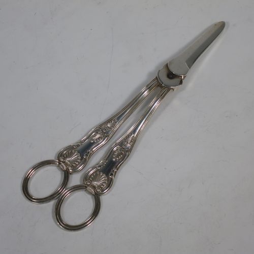 A very pretty Antique Victorian Sterling Silver pair of grape shears or scissors in the double struck Kings pattern with reeded handles. Made by Francis Higgins of London in 1893. The dimensions of this fine hand-made pair of antique silver grape scissors or shears are length 18 cms (7 inches), and they weigh approx. 124g (4 troy ounces).