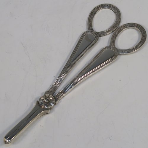 A very pretty Antique Victorian Sterling Silver pair of grape shears or scissors in the double struck Bead pattern. This beautiful pair of antique silver grape scissors were made by Henry Holland of London in 1878. The dimensions of this fine hand-made pair of antique silver grape shears are length 16.5 cms (6.5 inches), and they weigh approx. 81g (2.6 troy ounces).