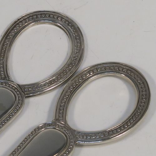A very pretty Antique Victorian Sterling Silver pair of grape shears or scissors in the double struck Bead pattern. This beautiful pair of antique silver grape scissors were made by Henry Holland of London in 1878. The dimensions of this fine hand-made pair of antique silver grape shears are length 16.5 cms (6.5 inches), and they weigh approx. 81g (2.6 troy ounces).