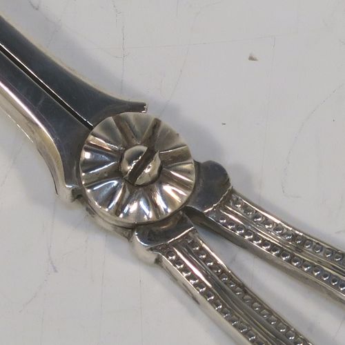 A very pretty Antique Victorian Sterling Silver pair of grape shears or scissors in the double struck Bead pattern. This beautiful pair of antique silver grape scissors were made by Henry Holland of London in 1878. The dimensions of this fine hand-made pair of antique silver grape shears are length 16.5 cms (6.5 inches), and they weigh approx. 81g (2.6 troy ounces).