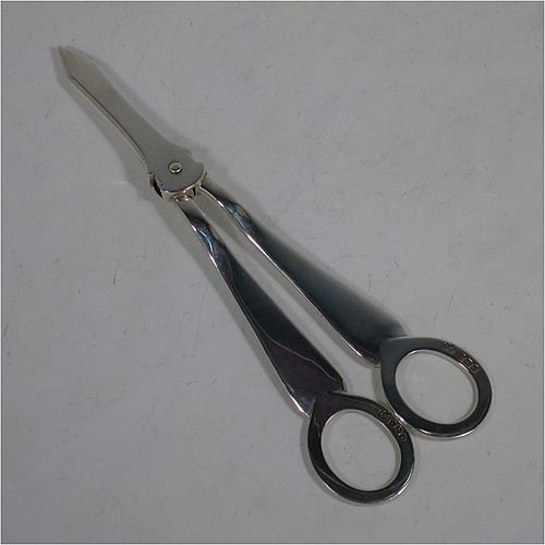 A very handsome Antique Edwardian Sterling Silver pair of grape shears or scissors in the single-struck hollow-ribbed Rattail pattern. Made by Elkington and Co., of Birmingham in 1909. The dimensions of this fine hand-made pair of antique silver grape scissors or shears are length 18 cms (7 inches), and they weigh approx. 115g (3.7 troy ounces).    