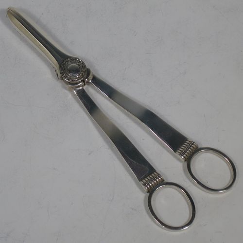 A handsome Art Deco style Sterling Silver pair of grape shears or scissors, with plain handles. Made by the Cooper Brothers of Sheffield in 1953. The dimensions of this fine hand-made pair of silver grape scissors or shears are length 16.5 cms (6.5 inches), and they weigh approx. 99g (3.2 troy ounces).    