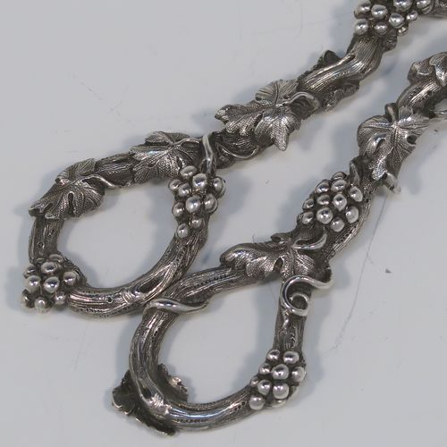 A very pretty and heavy Antique Victorian Sterling Silver pair of grape shears or scissors, having cast grapevine style handles. This beautiful silver pair of grape shears were made by Henry John Lias of London in 1864. The dimensions of this fine hand-made pair of antique silver grape scissors are length 19 cms (7.5 inches), and they weigh approx. 155g (5 troy ounces).   