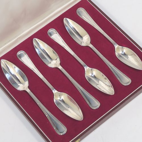 A large and very elegant set of Antique Edwardian Sterling Silver grape-fruit spoons, in the double-struck Reed and Ribbon pattern, having plain pointed oval bowls, and all in their original white satin and maroon velvet-lined presentation box. These beautiful antique silver grape-fruit spoons were made by William Hutton and Sons of London in 1908. The dimensions of these fine hand-made silver grapefruit spoons are length 15 cms (6 inches), and they weigh a total of 181g (5.8 troy ounces).