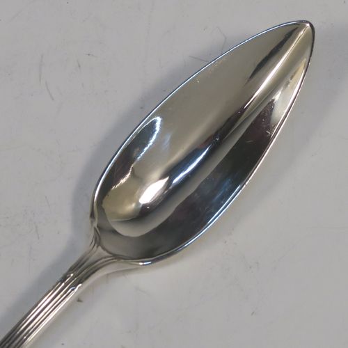 A large and very elegant set of Antique Edwardian Sterling Silver grape-fruit spoons, in the double-struck Reed and Ribbon pattern, having plain pointed oval bowls, and all in their original white satin and maroon velvet-lined presentation box. These beautiful antique silver grape-fruit spoons were made by William Hutton and Sons of London in 1908. The dimensions of these fine hand-made silver grapefruit spoons are length 15 cms (6 inches), and they weigh a total of 181g (5.8 troy ounces).
