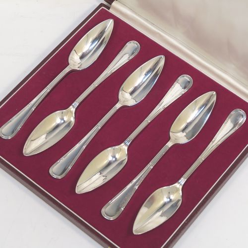 A large and very elegant set of Antique Edwardian Sterling Silver grape-fruit spoons, in the double-struck Reed and Ribbon pattern, having plain pointed oval bowls, and all in their original white satin and maroon velvet-lined presentation box. These beautiful antique silver grape-fruit spoons were made by William Hutton and Sons of London in 1908. The dimensions of these fine hand-made silver grapefruit spoons are length 15 cms (6 inches), and they weigh a total of 181g (5.8 troy ounces).