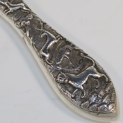 A beautiful Antique Victorian Indian Sterling Silver hand-mirror, having an oval body with a hand-chased scene of animals including lions, deer, dogs, leopards, and elephants, surrounding a central vacant round cartouche, and an oval mounted mirror in a plain frame. This fantastic silver hand mirror was probably made for the Indian market in ca. 1880. The dimensions of this fine hand-made silver hand mirror are length 28 cms (11 inches), and width of main body 11 cms (4.3 inches).