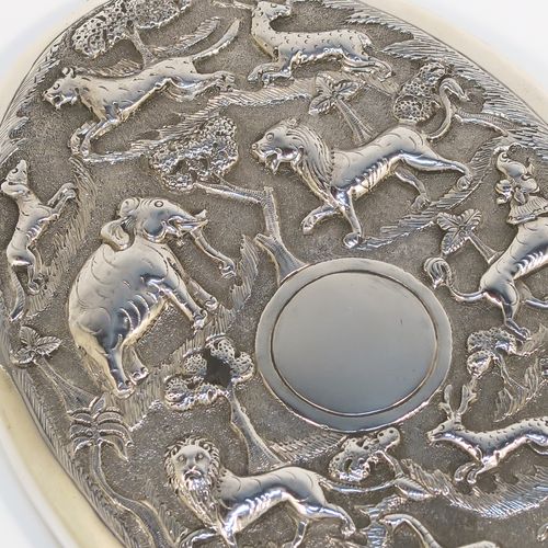 A beautiful Antique Victorian Indian Sterling Silver hand-mirror, having an oval body with a hand-chased scene of animals including lions, deer, dogs, leopards, and elephants, surrounding a central vacant round cartouche, and an oval mounted mirror in a plain frame. This fantastic silver hand mirror was probably made for the Indian market in ca. 1880. The dimensions of this fine hand-made silver hand mirror are length 28 cms (11 inches), and width of main body 11 cms (4.3 inches).