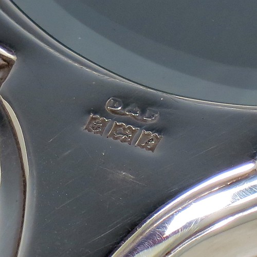 A very pretty Sterling Silver hand-mirror, having a shaped rectangular body with reeded borders, a hand-engraved back with floral decoration, and an original bevelled mirror. Made by Deakin and Francis of Birmingham in 1966. The dimensions of this fine hand-made silver hand mirror are length 26 cms (10.25 inches), and width 10 cms (4 inches).