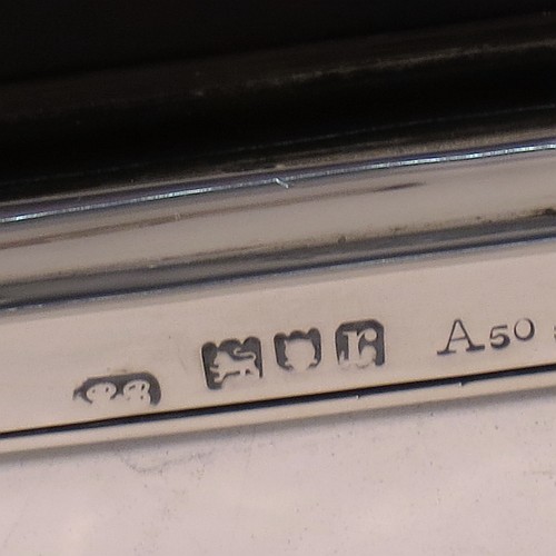 An Antique Sterling Silver and Tortoise-shell hand-mirror, having a rectangular body with shaped corners and reeded borders, a very pretty back with Neoclassical style inlaid tortoiseshell decoration, and an original bevelled mirror. Made in London in 1912. The dimensions of this fine hand-made antique silver and tortoise-shell hand mirror are length 30.5 cms (12 inches), and width of mirror 11 cms (4.25 inches).    
