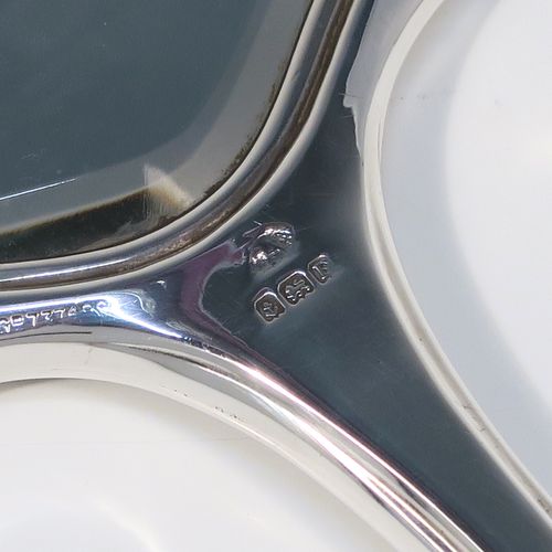 An elegant Sterling Silver and Tortoise-shell hand-mirror, having a shaped rectangular body, with original tortoiseshell back, and an original bevelled mirror. This handsome silver hand mirror was made by the Adie Brothers of Birmingham in 1930. The dimensions of this fine hand-made silver and tortoise-shell hand mirror are length 31 cms (12.25 inches), and width 11.5 cms (4.5 inches).   