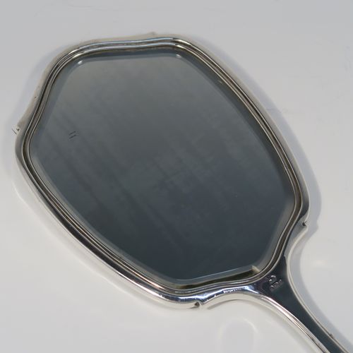 An elegant Sterling Silver and Tortoise-shell hand-mirror, having a shaped rectangular body, with original tortoiseshell back, and an original bevelled mirror. This handsome silver hand mirror was made by the Adie Brothers of Birmingham in 1930. The dimensions of this fine hand-made silver and tortoise-shell hand mirror are length 31 cms (12.25 inches), and width 11.5 cms (4.5 inches).   