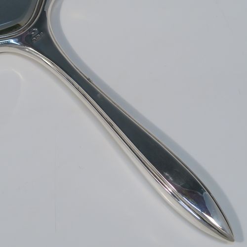 An elegant Sterling Silver and Tortoise-shell hand-mirror, having a shaped rectangular body, with original tortoiseshell back, and an original bevelled mirror. This handsome silver hand mirror was made by the Adie Brothers of Birmingham in 1930. The dimensions of this fine hand-made silver and tortoise-shell hand mirror are length 31 cms (12.25 inches), and width 11.5 cms (4.5 inches).   