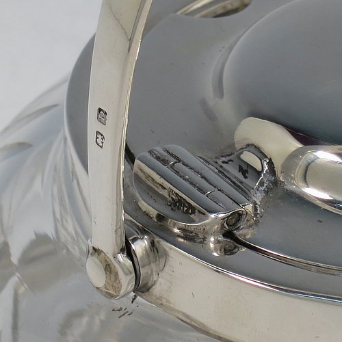A Sterling Silver and crystal honey or jam jar, having a round bellied body with hand-cut geometrical design and a star-cut base, a plain round mount, with a mechanical swing-handled hinged and domed lid. Made by Hukin & Heath of Birminghamn in 1928. The dimensions of this fine hand-made silver and glass conserve jar are height (inc. handle) 12.5 cms (5 inches), and diameter 11 cms (4.3 inches).