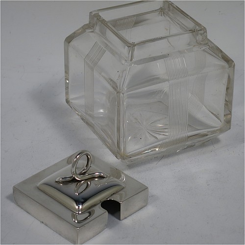 A very pretty Antique Edwardian sterling silver and hand-cut crystal jam, honey, or preserve jar, having a square body decorated with hand-engraved reeded vertical bands, and with sloping upper and lower borders, together with a square stepped pull-off silver lid with looped handle, and all sitting on a star-cut base. Made by Heath & Middleton of Birmingham in 1908. The dimensions of this fine hand-made antique silver and crystal jam or honey jar are height 9.5 cms (3.75 inches), and 7 cms (2.75 inches) square.