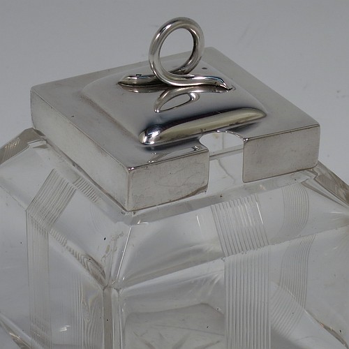 A very pretty Antique Edwardian sterling silver and hand-cut crystal jam, honey, or preserve jar, having a square body decorated with hand-engraved reeded vertical bands, and with sloping upper and lower borders, together with a square stepped pull-off silver lid with looped handle, and all sitting on a star-cut base. Made by Heath & Middleton of Birmingham in 1908. The dimensions of this fine hand-made antique silver and crystal jam or honey jar are height 9.5 cms (3.75 inches), and 7 cms (2.75 inches) square.