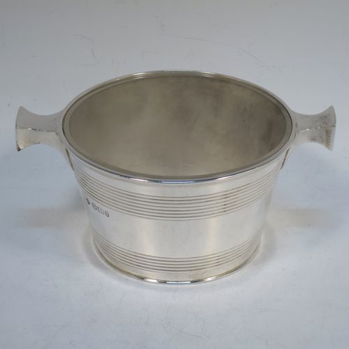 A very handsome Antique Victorian Sterling Silver and crystal honey, jam, or conserve jar, in the shape of a Quaich, having a plain round body with tapering sides and reeded decoration, two side handles, and with a frosted cut crystal insert with a star-cut base. Made by Martin Hall and Co., of Sheffield in 1896. The dimensions of this fine hand-made silver and crystal Quaich style conserve, jam, or honey jar are height 6 cms (5.5 inches), diameter 10 cms (4 inches), and it weighs approx. 235g (7.6 troy ounces).  
