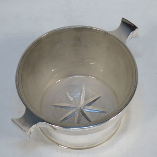 A very handsome Antique Victorian Sterling Silver and crystal honey, jam, or conserve jar, in the shape of a Quaich, having a plain round body with tapering sides and reeded decoration, two side handles, and with a frosted cut crystal insert with a star-cut base. Made by Martin Hall and Co., of Sheffield in 1896. The dimensions of this fine hand-made silver and crystal Quaich style conserve, jam, or honey jar are height 6 cms (5.5 inches), diameter 10 cms (4 inches), and it weighs approx. 235g (7.6 troy ounces).