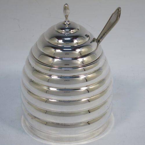 A very unusual Sterling Silver and crystal honey, jam, or conserve jar, in the shape of a bee-hive with a lift off lid, and having a plain round glass insert. Made in the circa 1930 and possibly continental in origin. The dimensions of this fine hand-made silver and crystal conserve, jam, or honey jar in the shape of a beehive are height 12 cms (4.75 inches), and diameter at base 9 cms.  