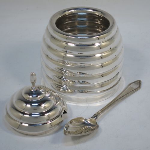 A very unusual Sterling Silver and crystal honey, jam, or conserve jar, in the shape of a bee-hive with a lift off lid, and having a plain round glass insert. Made in the circa 1930 and possibly continental in origin. The dimensions of this fine hand-made silver and crystal conserve, jam, or honey jar in the shape of a beehive are height 12 cms (4.75 inches), and diameter at base 9 cms.