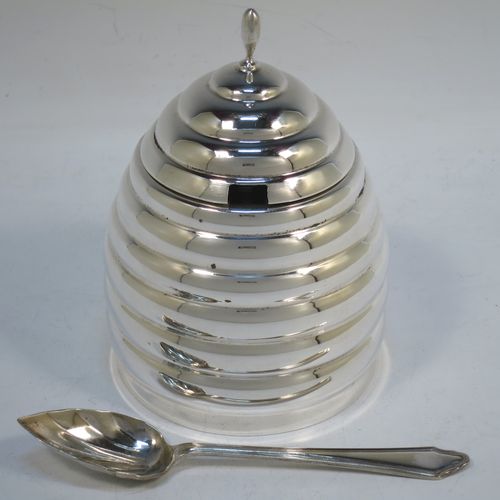 A very unusual Sterling Silver and crystal honey, jam, or conserve jar, in the shape of a bee-hive with a lift off lid, and having a plain round glass insert. Made in the circa 1930 and possibly continental in origin. The dimensions of this fine hand-made silver and crystal conserve, jam, or honey jar in the shape of a beehive are height 12 cms (4.75 inches), and diameter at base 9 cms.