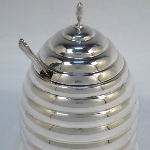 A very unusual Sterling Silver and crystal honey, jam, or conserve jar, in the shape of a bee-hive with a lift off lid, and having a plain round glass insert. Made in the circa 1930 and possibly continental in origin. The dimensions of this fine hand-made silver and crystal conserve, jam, or honey jar in the shape of a beehive are height 12 cms (4.75 inches), and diameter at base 9 cms.