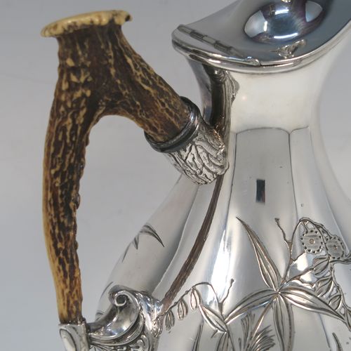 A beautiful and unusual Aesthetic style Antique Victorian Silver-Plated hot water or milk pot, having a round bellied body, with hand-chased butterfly and floral decoration, a horn antler handle, a hinged lid with a finial, and all sitting on a round pedestal foot. This beautiful antique Aesthetic silver plated hot milk or water pot was made by James Dixon and Sons of Sheffield in ca. 1880. The dimensions of this fine hand-made antique silver-plated serving pot are height 22 cms (8.75 inches), and length 14 cms (5.5 inches).   