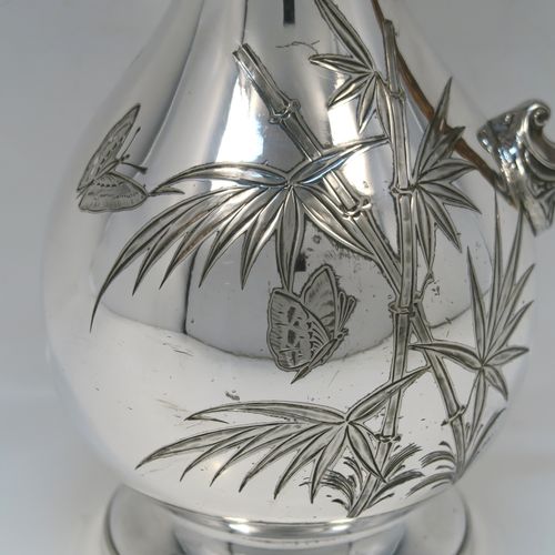 A beautiful and unusual Aesthetic style Antique Victorian Silver-Plated hot water or milk pot, having a round bellied body, with hand-chased butterfly and floral decoration, a horn antler handle, a hinged lid with a finial, and all sitting on a round pedestal foot. This beautiful antique Aesthetic silver plated hot milk or water pot was made by James Dixon and Sons of Sheffield in ca. 1880. The dimensions of this fine hand-made antique silver-plated serving pot are height 22 cms (8.75 inches), and length 14 cms (5.5 inches).   