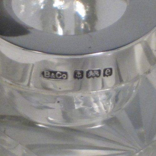 Antique Edwardian sterling silver and hand-cut crystal inkstand, having a rectangular body with chamfered corners, a pen holder groove above a curved front face, plain round silver mount with a hinged lid having an applied floral border, and all sitting on a star-cut flat base. Made by Broadway & Co., of Birmingham in 1904. The dimensions of this fine hand-made silver and crystal inkstand are height 5 cms (2 inches), length 10 cms (4 inches), and width 6.5 cms (2.5 inches).   