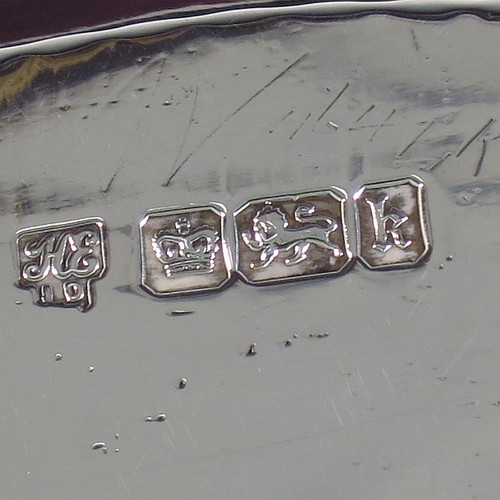 An Antique Edwardian Sterling Silver two bottle double inkstand, with an oval boat-shaped body, having a hand-pierced gallery border and hand-engraved ends with neoclassical style engraving, two removable cut-crystal ink bottles with hinged lids, and all sitting on four cast flanged feet. Made by Hawksworth and Eyre of Sheffield in 1902. The dimensions of this fine hand-made antique sterling silver double inkstand are length 28 cms (11 inches), width 14 cms (5.5 inches), and it weighs approx. 350g (11.2 troy ounces).  