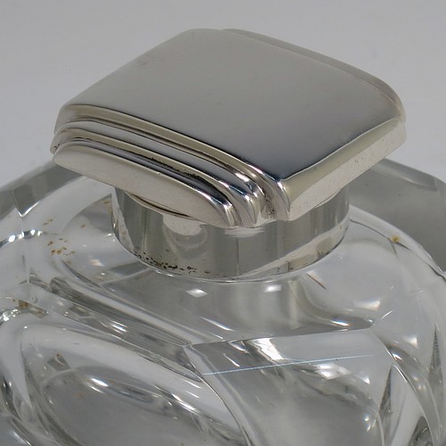 A very handsome Art Deco Sterling Silver and hand-cut crystal inkstand, having a rectangular body with rounded corners and panelled faces, a plain round silver mount with a square hinged lid having hand-chased stepped decoration, a removable small glass liner, and all sitting on a plain cut flat base. Made by the F. C. Richards of Birmingham in 1938. The dimensions of this fine hand-made silver and crystal inkstand are height 8.5 cms (3.25 inches), length 10 cms (4 inches), and width 7 cms (2.75 inches).    