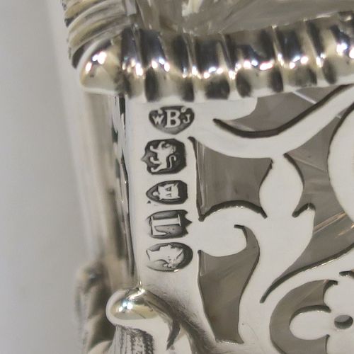 A very pretty Antique Victorian Sterling Silver gallery inkstand, having hand-pierced scroll and floral decoration, applied gadroon borders, two removable crystal inkwells with hinged lids, and all sitting on four cast foliate feet. This beautiful antique silver galleried inkstand was made by William J. Barnard of London in 1886. The dimensions of this fine hand-made silver inkstand are length 22 cms (8.75 inches), width 13 cms (5 inches), height 8 cms (3 inches), and it weighs approx. 620g (20 troy ounces).  