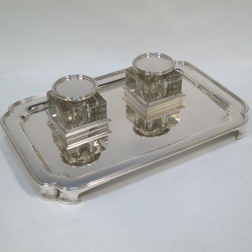 A very elegant and large Sterling Silver heavy table inkstand, having a plain rectangular body, with cut corners, two removable square crystal ink-wells with hinged round silver lids, all sitting on four cast flange feet. Made by Henry H. Plante of London in 1963. The dimensions of this fine hand-made table inkstand are length 25.5 cms (10 inches), width 17 cms (6.75 inches), and it weighs a total of approx. 650g (21 troy ounces).   