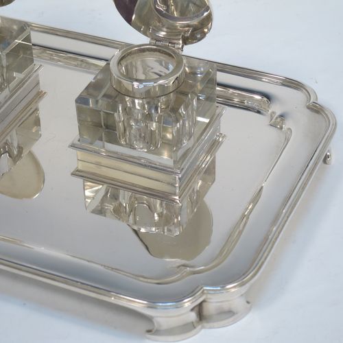 A very elegant and large Sterling Silver heavy table inkstand, having a plain rectangular body, with cut corners, two removable square crystal ink-wells with hinged round silver lids, all sitting on four cast flange feet. Made by Henry H. Plante of London in 1963. The dimensions of this fine hand-made table inkstand are length 25.5 cms (10 inches), width 17 cms (6.75 inches), and it weighs a total of approx. 650g (21 troy ounces).